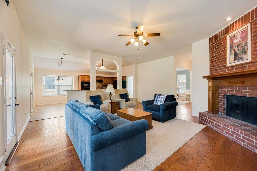 1485 Ashbourne Drive, Rockwall, TX 75087 Brick fireplace with a wood mantel
