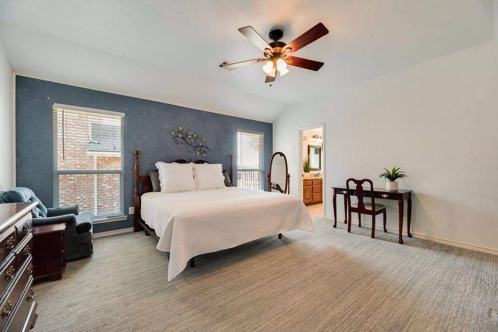 1485 Ashbourne Drive, Rockwall, TX 75087 Spacious room featuring vaulted ceilings, a ceiling fan, carpet flooring, and multiple windows with blinds