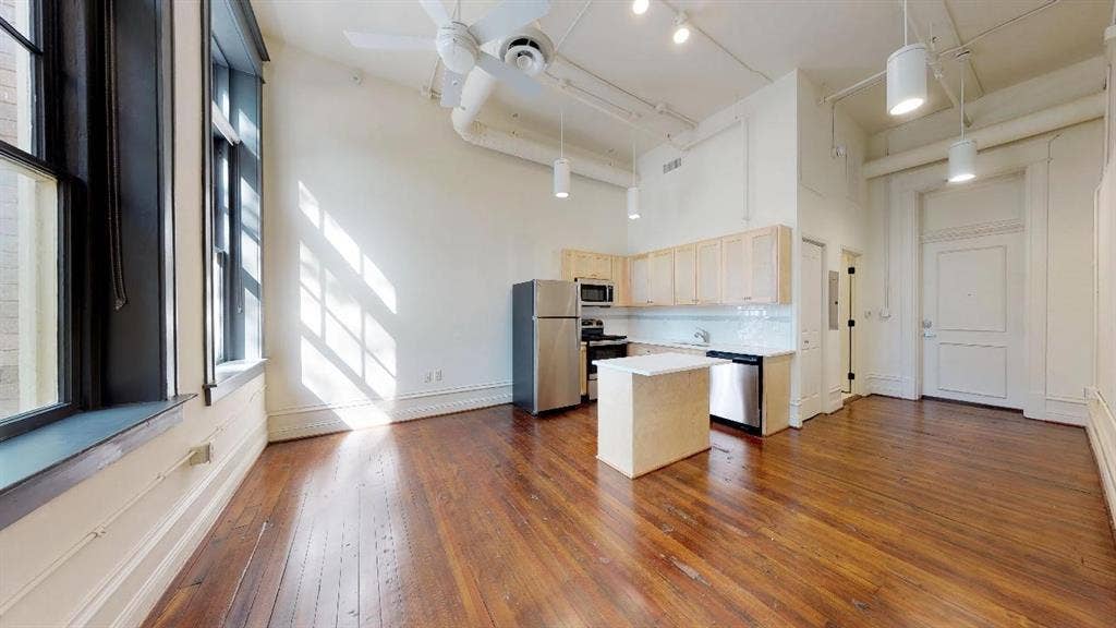 401 N Carroll Avenue, #1206, Dallas, TX 75246 Kitchen featuring stainless steel appliances, dark hardwood / wood-style floors, a towering ceiling, tasteful backsplash, and ceiling fan