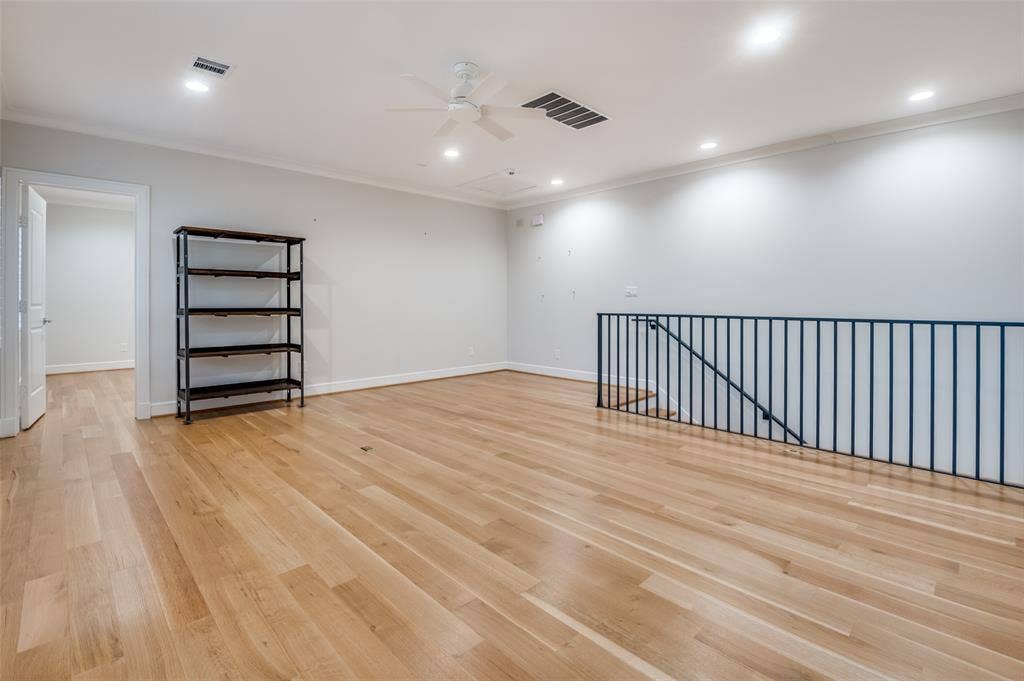 4031 Prescott Avenue, Dallas, TX 75219 Hardwood flooring, recessed lighting, ceiling fan, crown molding, and wrought iron railing