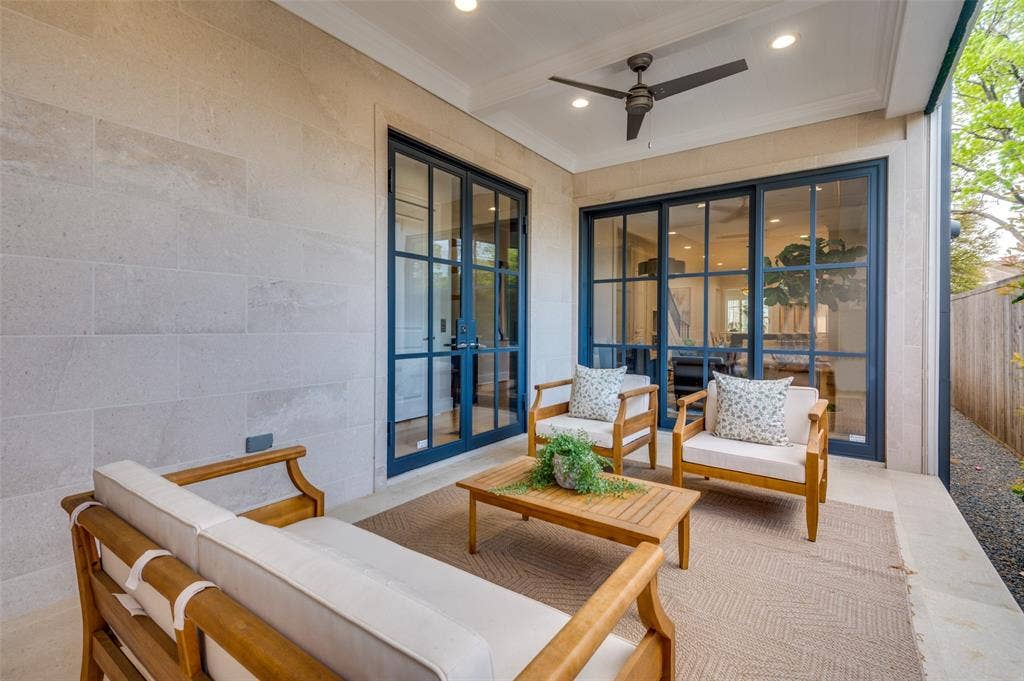 4031 Prescott Avenue, Dallas, TX 75219 Covered outdoor patio featuring light-toned stone block exterior, ceiling fan with integrated lighting, recessed lighting, and expansive glass panel doors