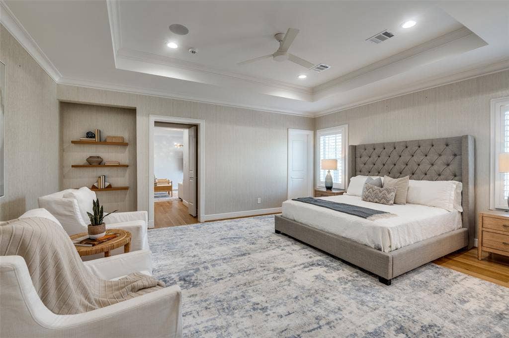 4031 Prescott Avenue, Dallas, TX 75219 Tray ceiling with recessed lighting and a ceiling fan, hardwood flooring, built-in shelving, and plantation shutters