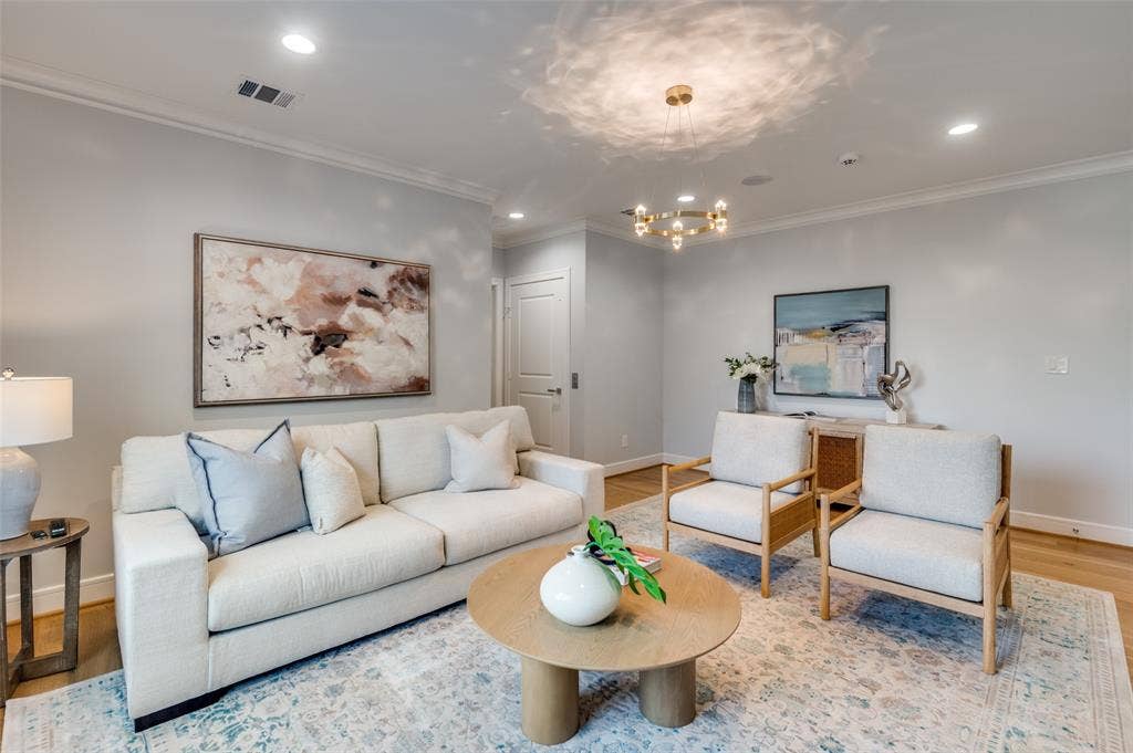 4031 Prescott Avenue, Dallas, TX 75219 Recessed lighting, crown molding, wood-finish flooring, and a modern chandelier