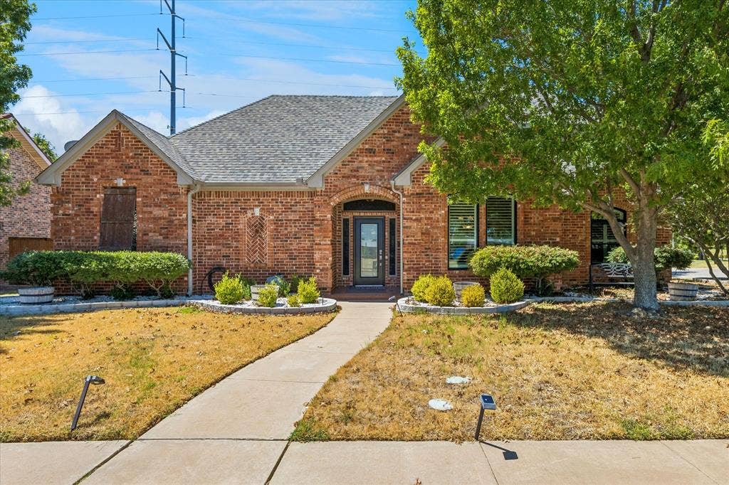 3800 Deer Forest Drive, Denton, TX 76208 Brick exterior with a gabled roof and covered entry
