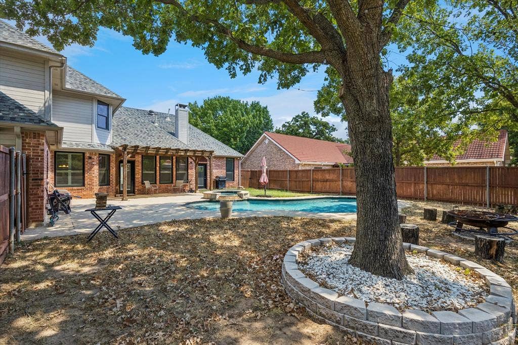 3800 Deer Forest Drive, Denton, TX 76208 Expansive backyard featuring a swimming pool, paved patio, and a shaded pergola