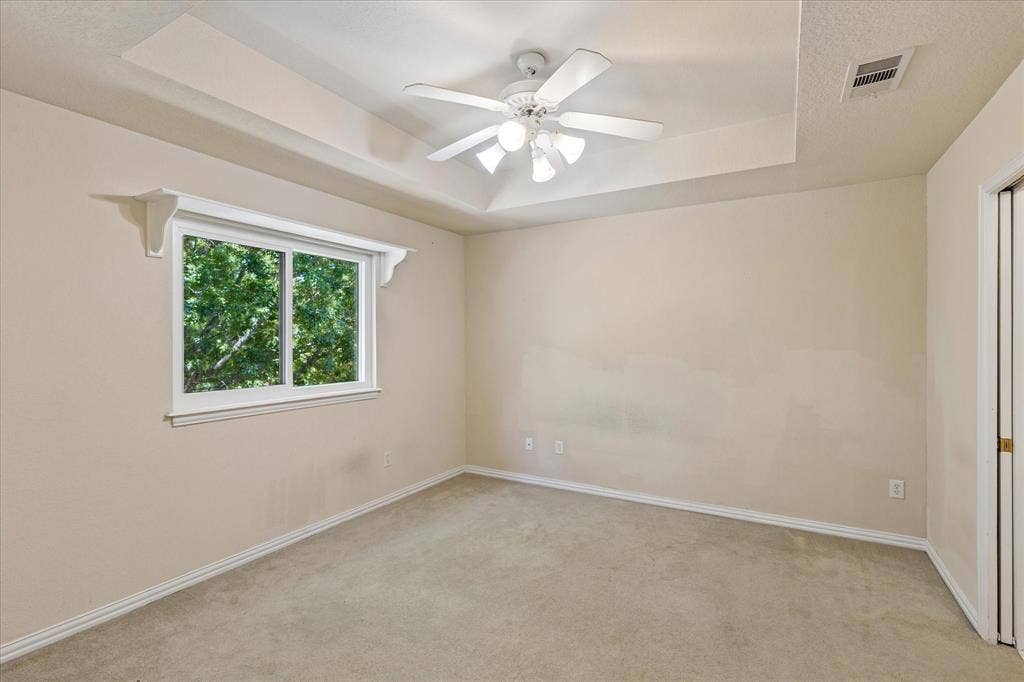3800 Deer Forest Drive, Denton, TX 76208 Recessed ceiling with a ceiling fan, carpeted flooring, and a double-pane window with decorative corbels