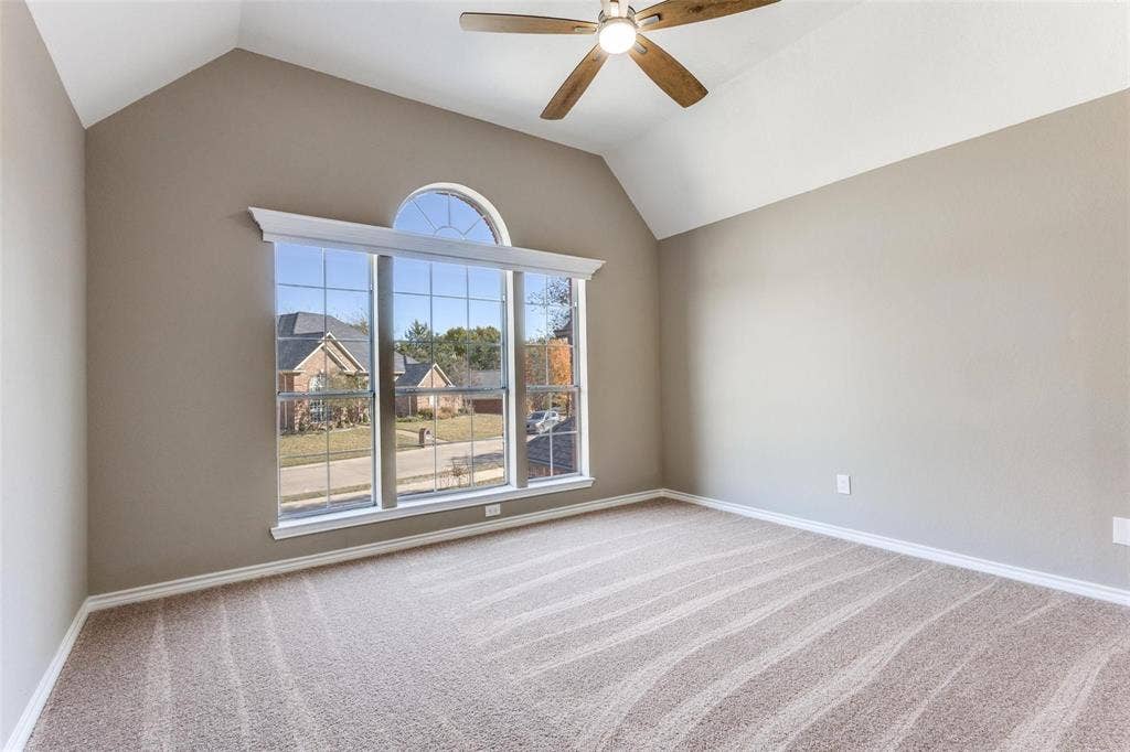 2822 Roundrock, McKinney, TX 75072 Bedroom upstairs has vaulted ceiling, ceiling fan, arched window with transom, and NEW neutral carpeting