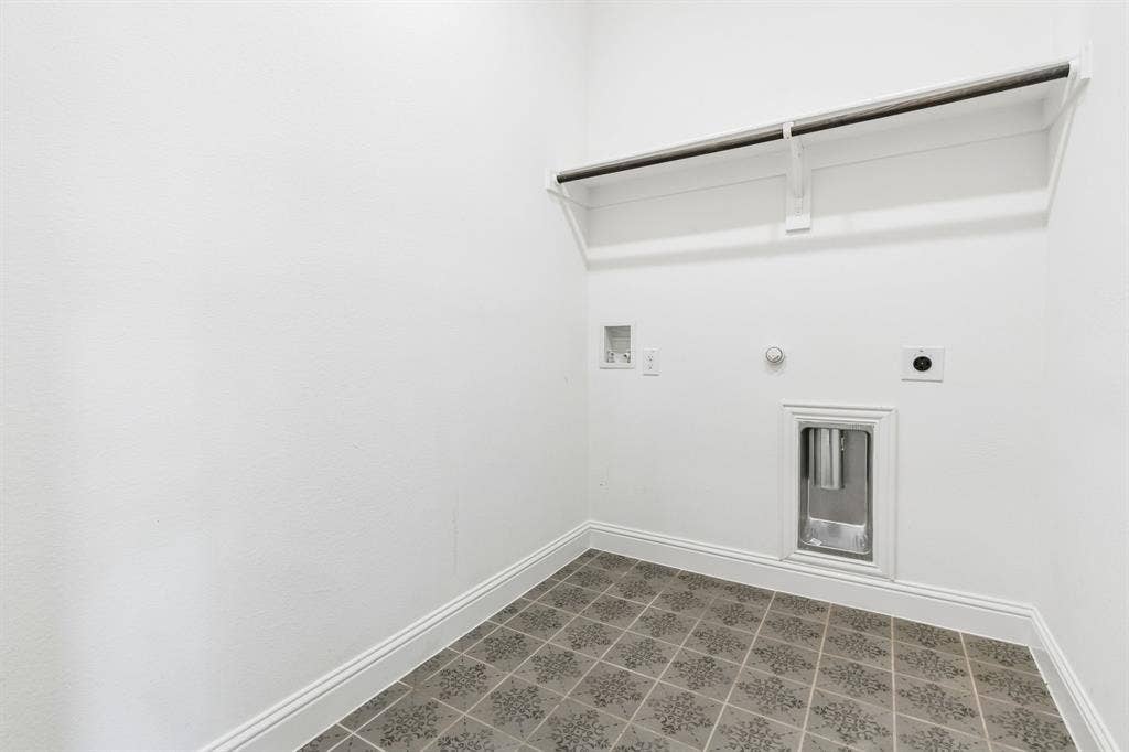 5224 Troupe Road, McKinney, TX 75071 Laundry area with patterned floor tile, white walls, and a built-in shelf with hanging rod