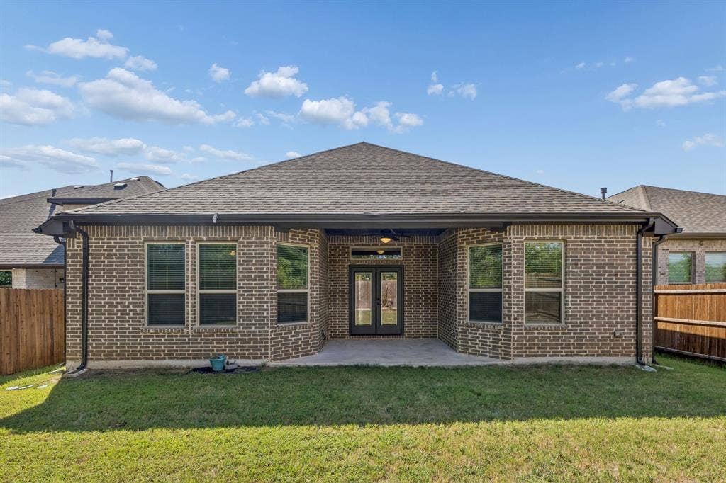 5224 Troupe Road, McKinney, TX 75071 Brick exterior with a covered patio, multiple windows, and a shingled roof