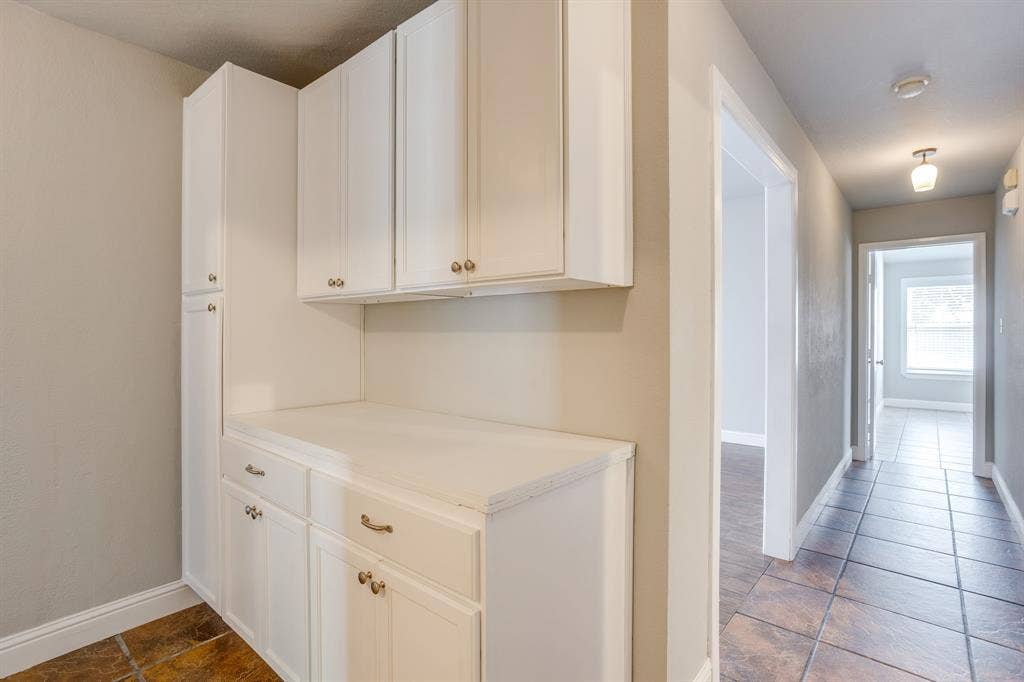 9825 Stoney Bridge Road, Fort Worth, TX 76108 Hall storage and folding counter near laundry room