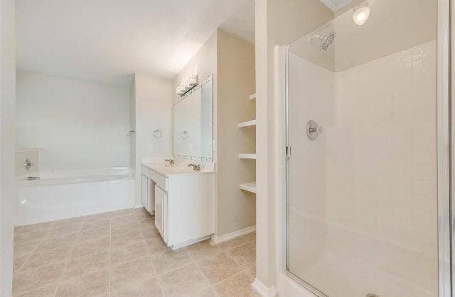 1405 Teal Way, Midlothian, TX 76065 Tiled flooring, dual vanity with undermount sinks, built-in shelving, shower enclosure, and a soaking tub