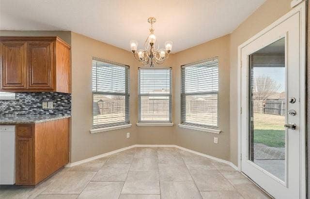 1405 Teal Way, Midlothian, TX 76065 Bay window with three panes, tile flooring, glass-paneled door, hanging chandelier, and wood-finish cabinetry