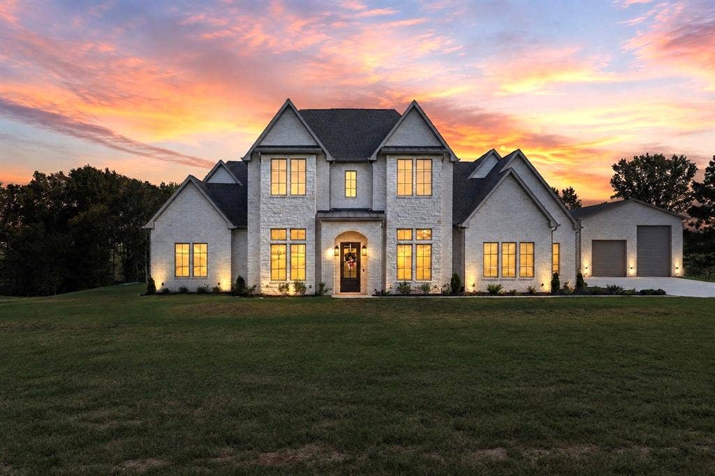 23180 Bridle View Drive, Lindale, TX 75771 Stone facade with dark roof, multiple gables, and an attached two-car garage
