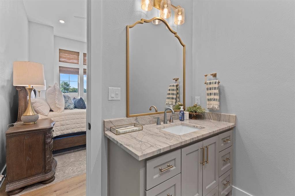 23180 Bridle View Drive, Lindale, TX 75771 Single vanity with a light gray cabinet, a neutral-toned countertop, and an undermount sink