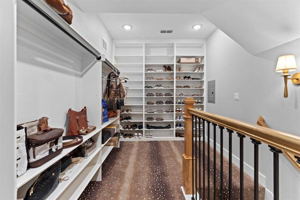 23180 Bridle View Drive, Lindale, TX 75771 Custom built-in shelving, recessed lighting, wood-finish flooring, and a metal and wood balustrade