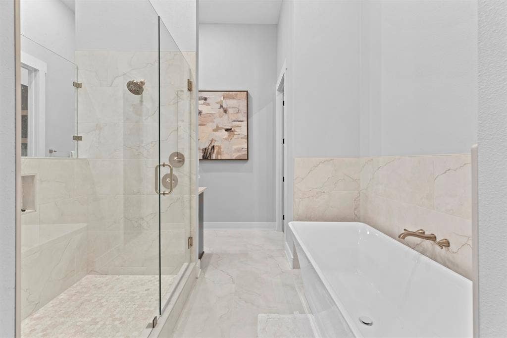 23180 Bridle View Drive, Lindale, TX 75771 Walk-in shower with clear glass enclosure, integrated bench, and mosaic tile floor