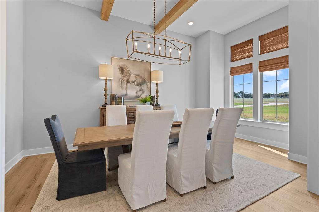 23180 Bridle View Drive, Lindale, TX 75771 Vaulted ceiling with exposed wood beams, wood-finish flooring, large windows with natural light, modern chandelier, and built-in buffet