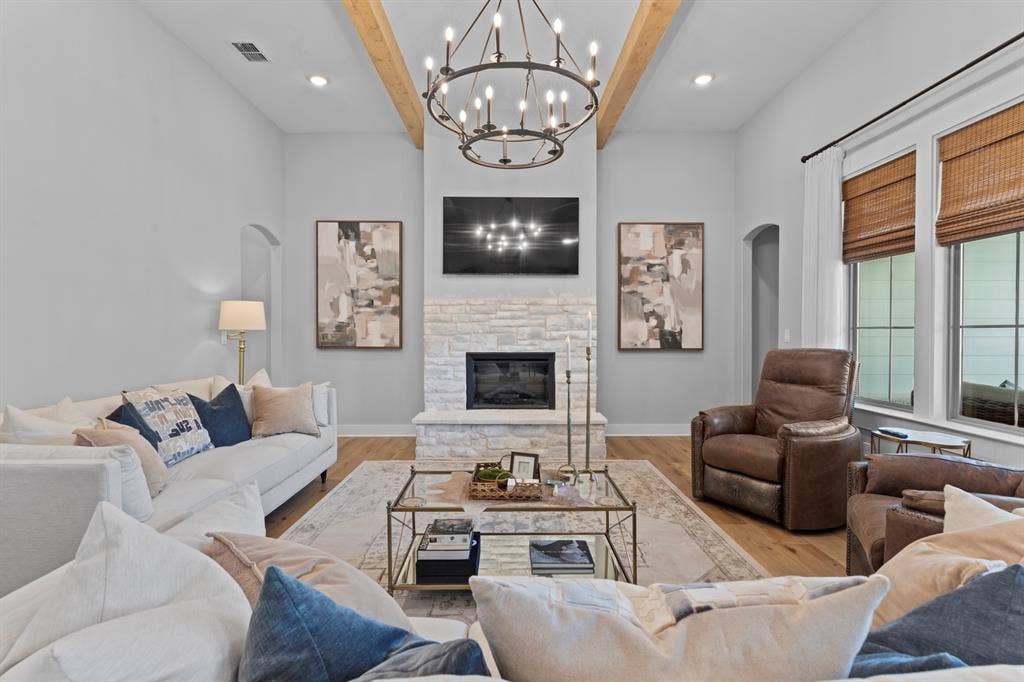 23180 Bridle View Drive, Lindale, TX 75771 Sophisticated living room anchored by a linear fireplace with stacked stone surround and built-in shelving