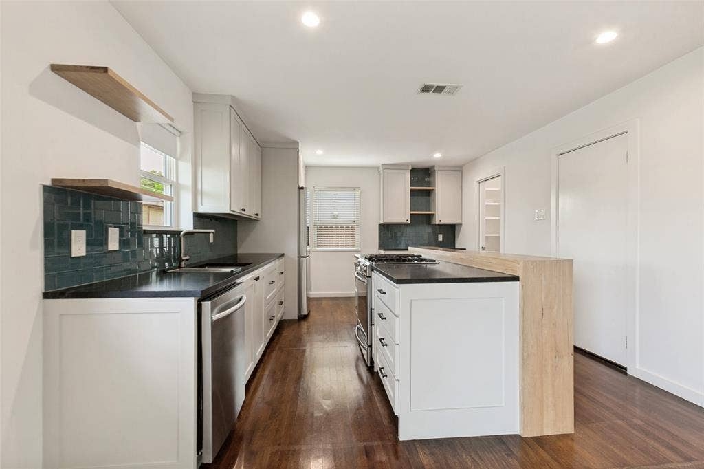 2413 Patricia Lane, Garland, TX 75041 Kitchen with stainless steel appliances and stone countertops