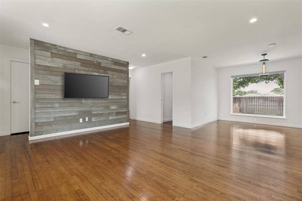 2413 Patricia Lane, Garland, TX 75041 Living Room with views of the backyard, doorway leading to full bathroom