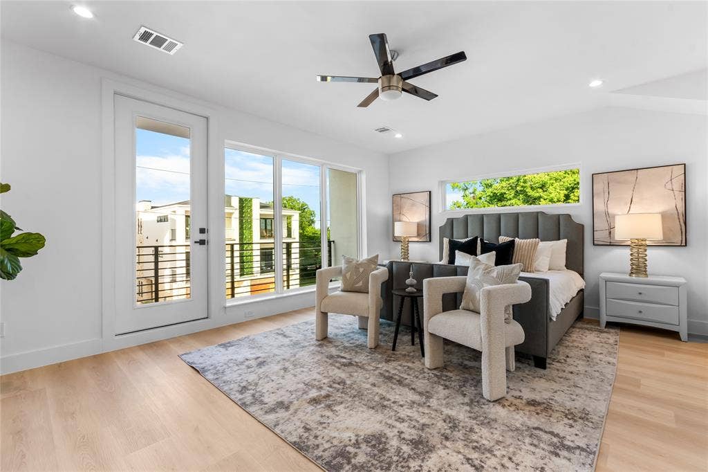 Bedroom featuring light wood-finish flooring and a contemporary ceiling fan