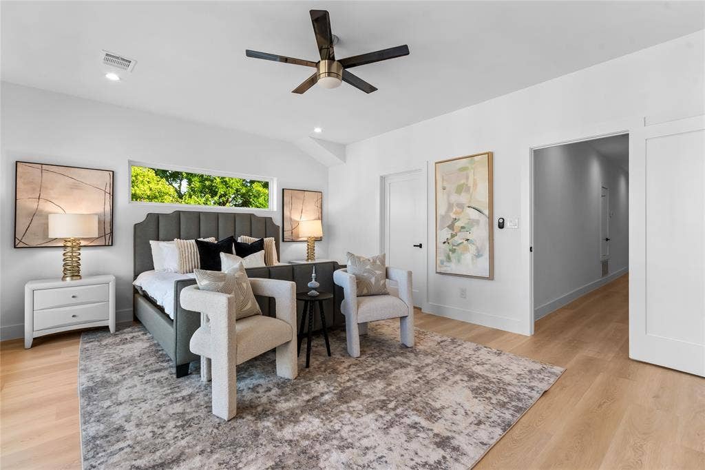 Bright bedroom with vaulted ceilings, recessed lighting, a modern ceiling fan, and light wood-finish flooring