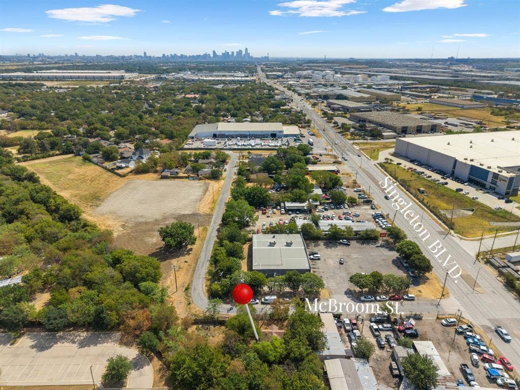 5005 Mcbroom Street, Dallas, TX 75212 Expansive lot featuring street frontage on McBroom Street, proximity to Singleton Boulevard, and a distant city skyline