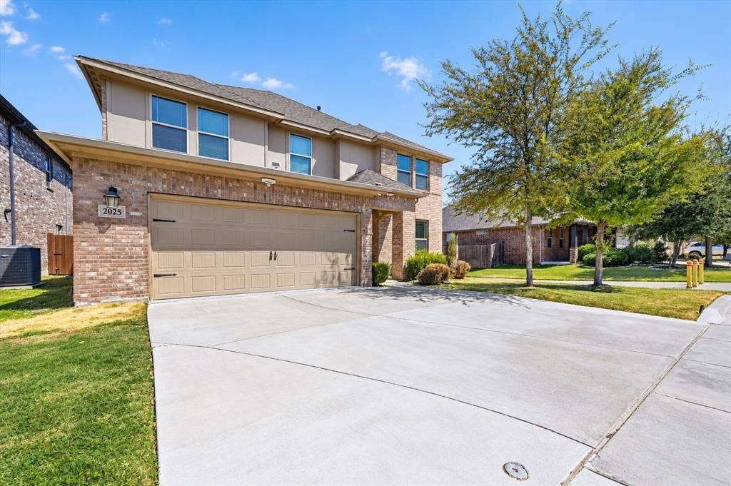 2025 Lake Front Trail, Garland, TX 75043 Brick and stucco exterior with an attached two-car garage