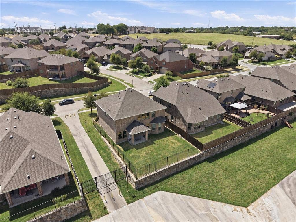 2025 Lake Front Trail, Garland, TX 75043 Residential community featuring multi-story homes with shingle roofs and fenced backyards
