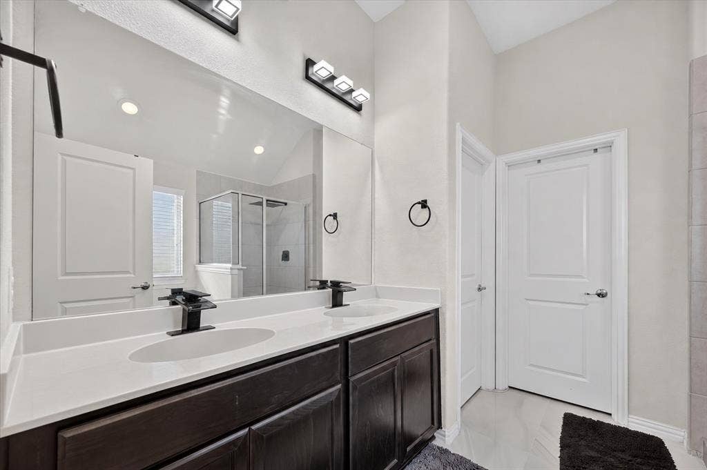 2025 Lake Front Trail, Garland, TX 75043 Dual vanity with undermount sinks, dark wood-finish cabinetry, and white countertops