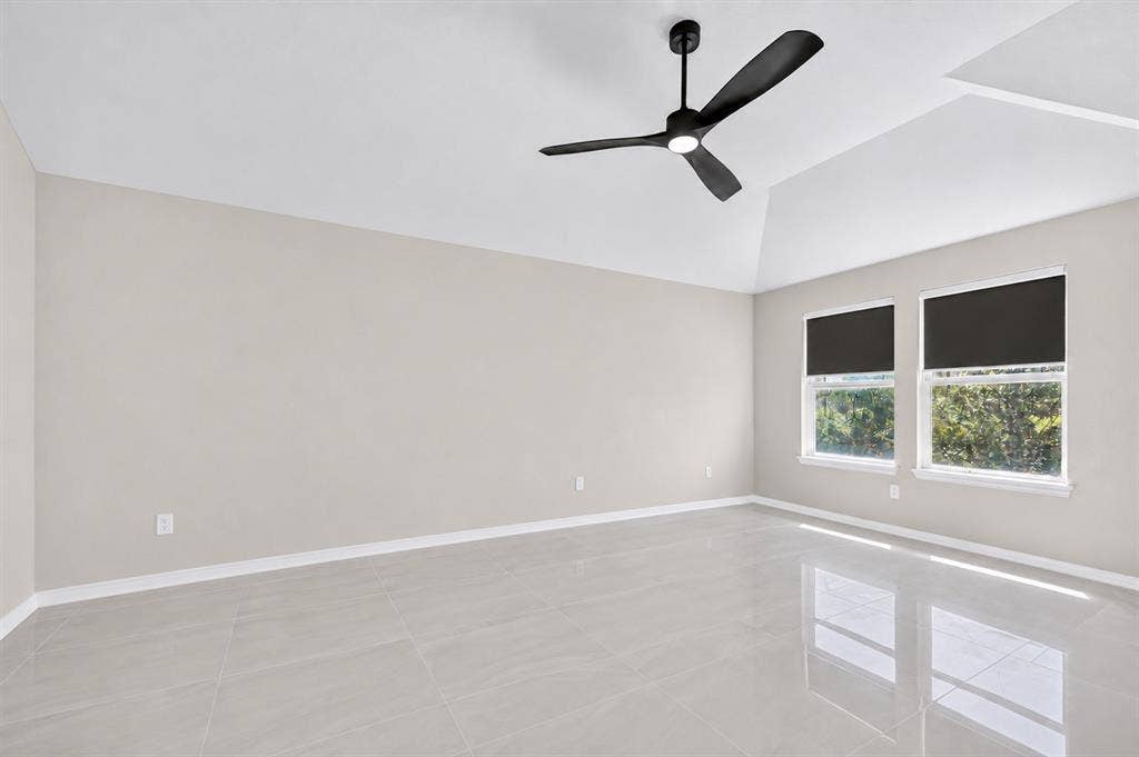 2025 Lake Front Trail, Garland, TX 75043 Spacious room featuring vaulted ceilings, light-toned walls, and large format tile flooring