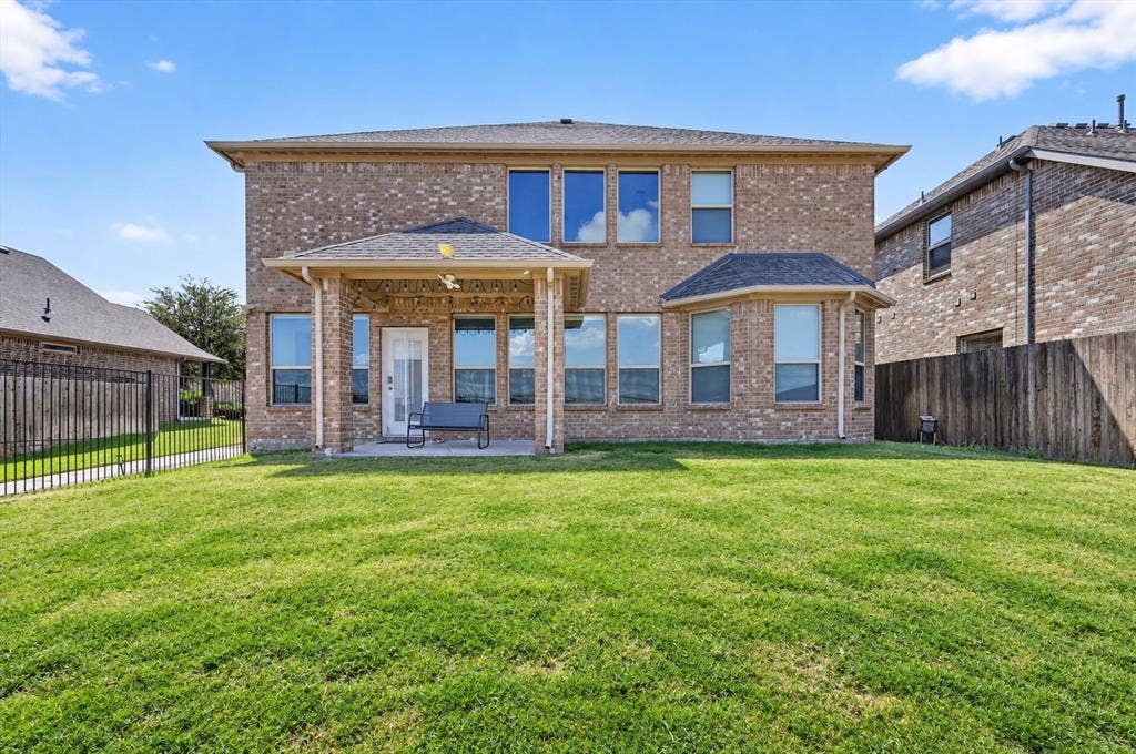 2025 Lake Front Trail, Garland, TX 75043 Expansive green lawn, brick exterior with multiple windows, covered patio, and a bay window feature