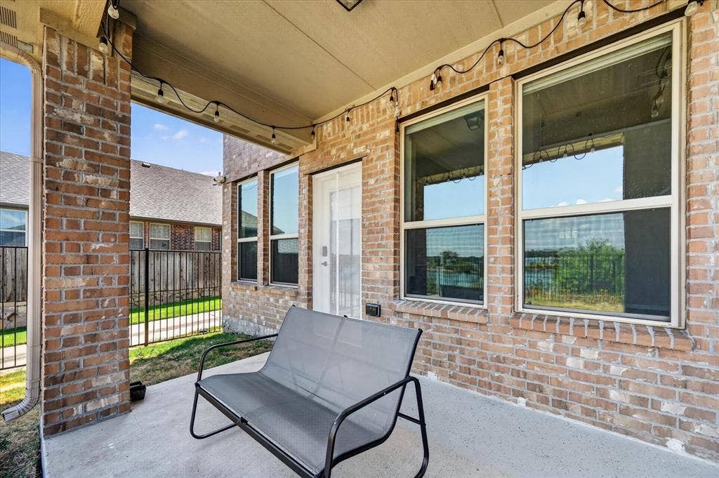 2025 Lake Front Trail, Garland, TX 75043 Covered patio featuring brick construction, concrete flooring, and multiple windows