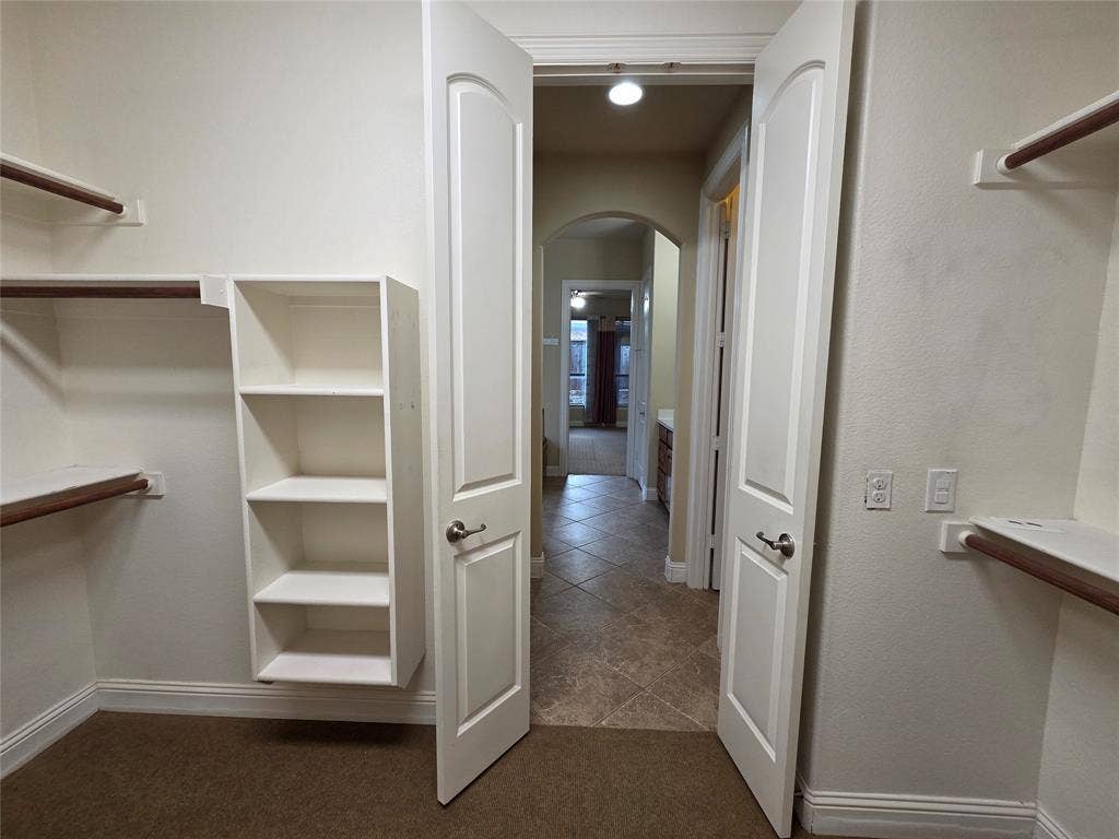 146 Rolling Fork Bend, Irving, TX 75039 Built-in shelving, hanging rods, and carpeting