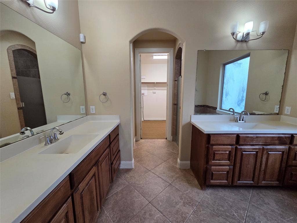 146 Rolling Fork Bend, Irving, TX 75039 Dual vanity with white countertops and wood cabinetry