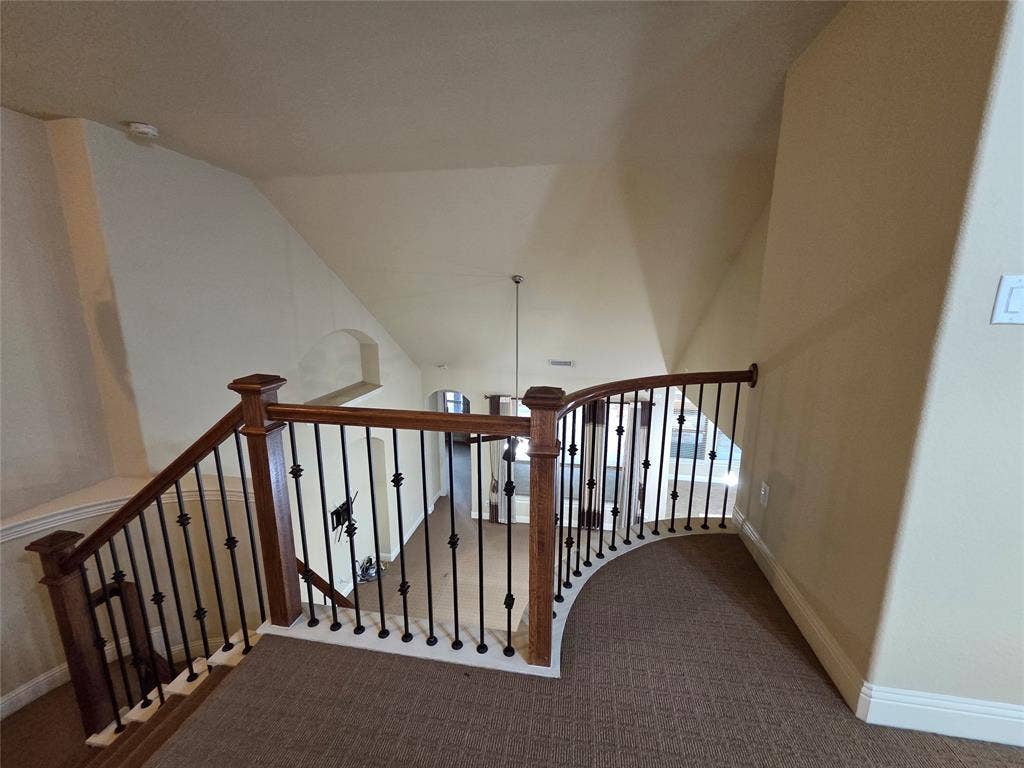 146 Rolling Fork Bend, Irving, TX 75039 Carpeted landing with wood railing and black wrought iron spindles
