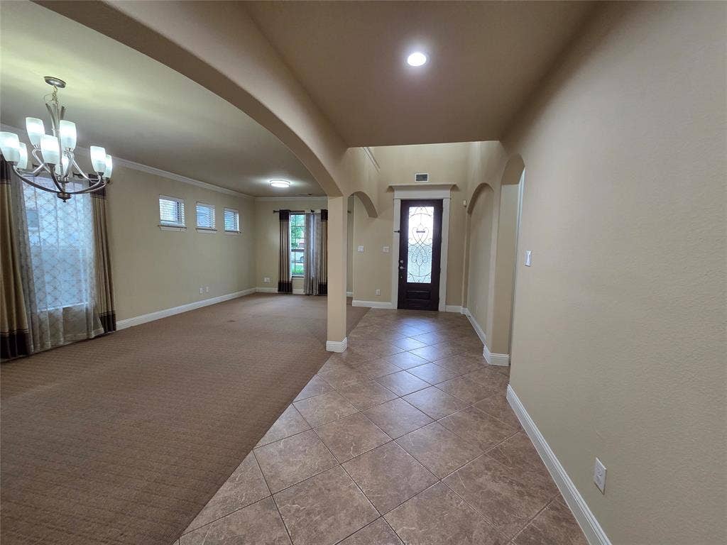 146 Rolling Fork Bend, Irving, TX 75039 Tiled entryway flooring, arched doorways, an ornate front door, a chandelier, and recessed lighting