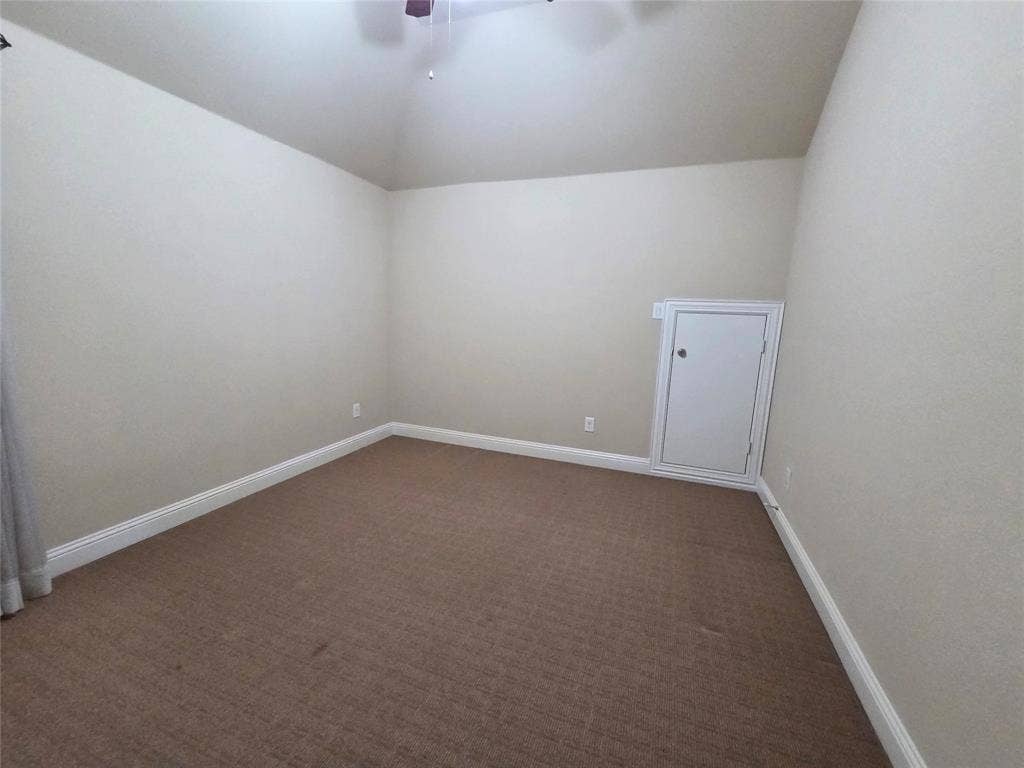 146 Rolling Fork Bend, Irving, TX 75039 Vaulted ceiling, neutral wall paint, brown carpet flooring, white trim, and a built-in storage access panel