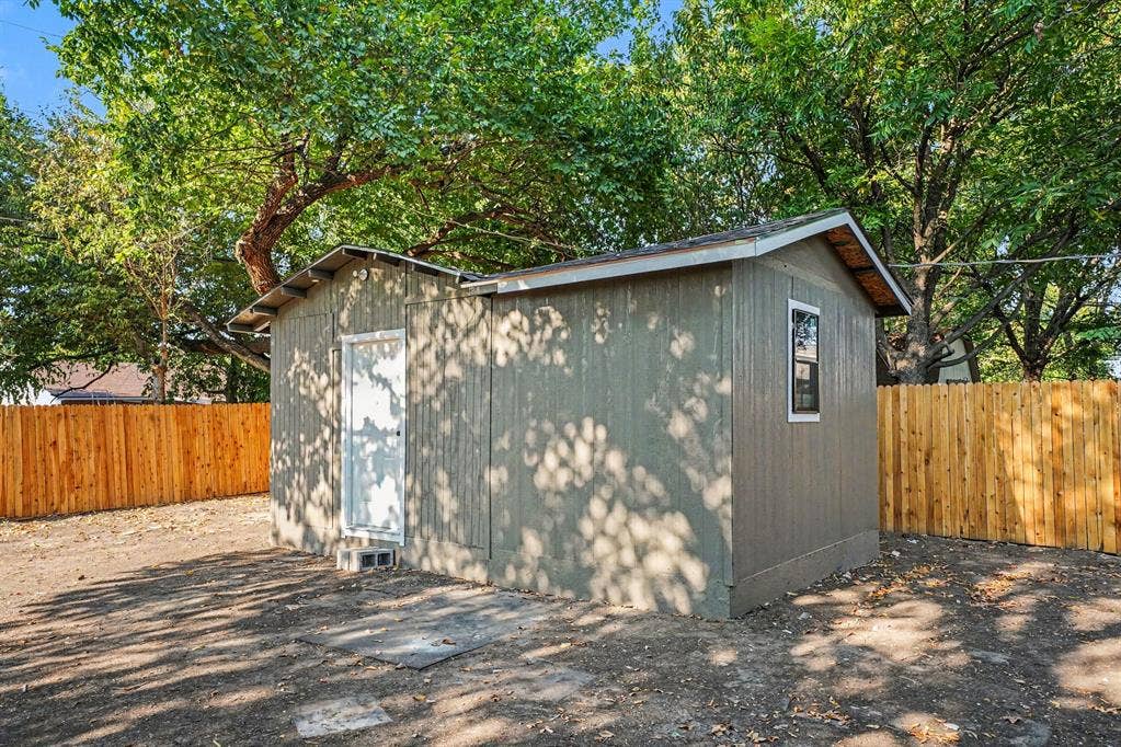 2429 February Lane, Grand Prairie, TX 75050 Detached outbuilding with an exterior window, a solid door, and a gable roof