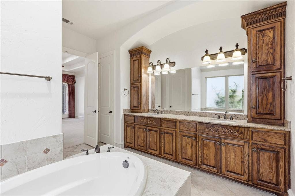 420 Silverado Trail, Keller, TX 76248 Dual vanity with wood cabinetry, light-colored countertop, and integrated sinks