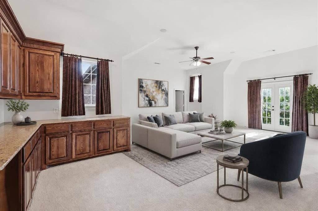 420 Silverado Trail, Keller, TX 76248 Built-in wooden cabinetry with a light-toned countertop, double French doors, a ceiling fan, vaulted ceiling, and carpeted flooring