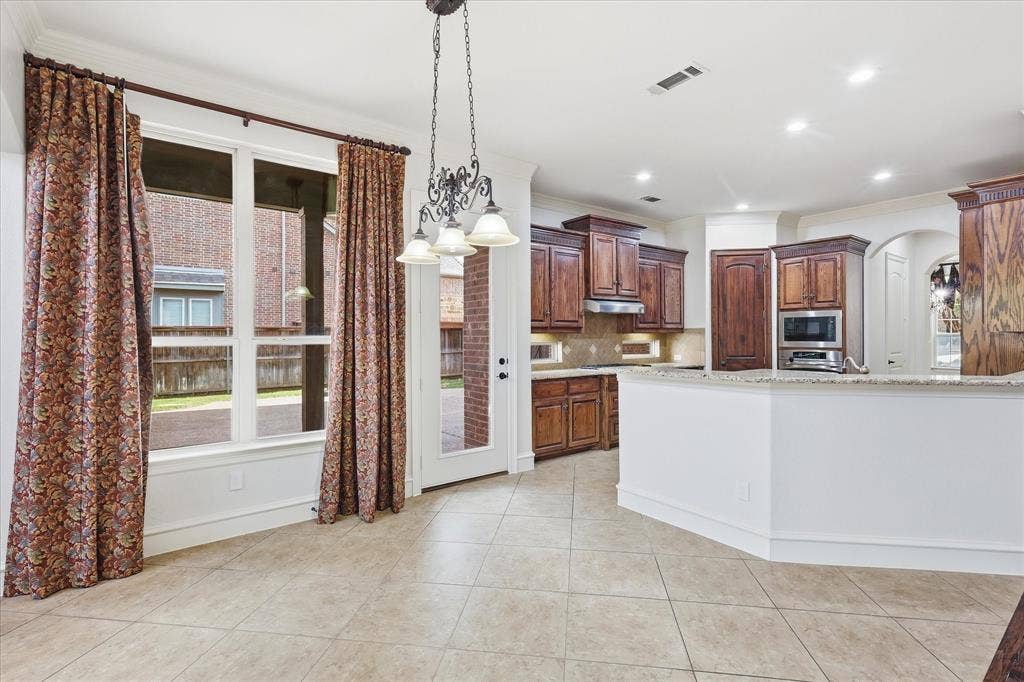 420 Silverado Trail, Keller, TX 76248 Kitchen featuring wood cabinetry, stainless steel appliances, and a pass-through counter