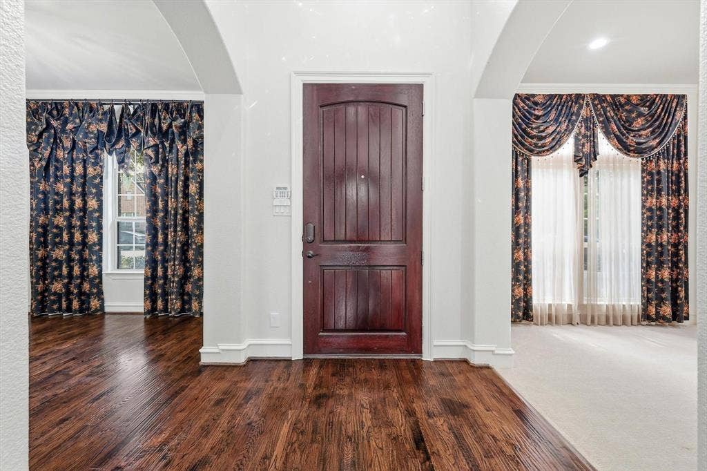420 Silverado Trail, Keller, TX 76248 Rich wood-paneled entry door, arched doorways, hardwood flooring, and recessed lighting