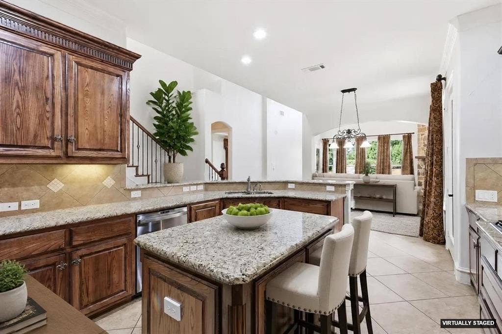 420 Silverado Trail, Keller, TX 76248 Kitchen featuring wood cabinetry, granite countertops, tile flooring, and stainless steel appliances