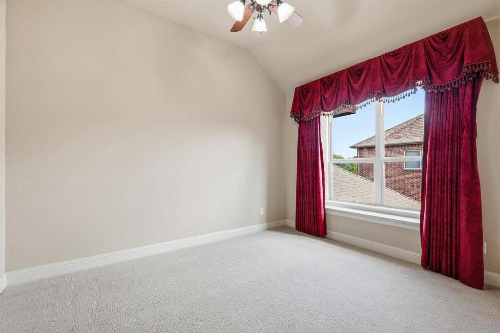 420 Silverado Trail, Keller, TX 76248 Vaulted ceiling with a ceiling fan, carpeted flooring, and a large window