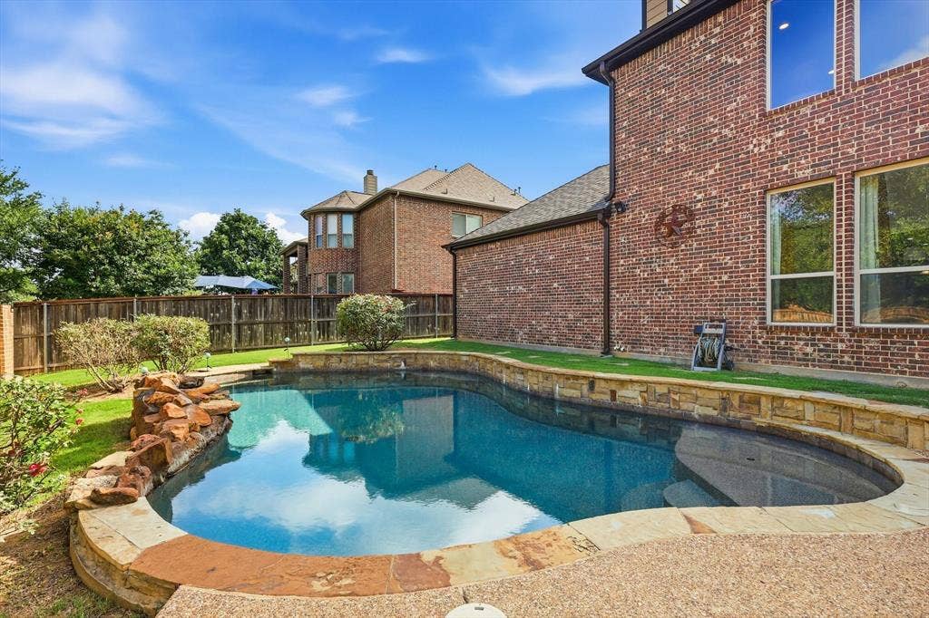 420 Silverado Trail, Keller, TX 76248 Curved swimming pool with stone coping and rock water feature