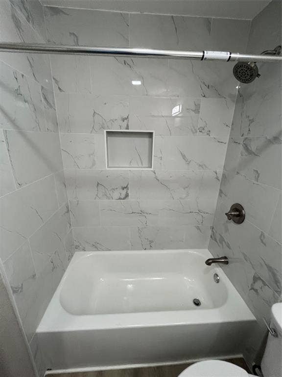 9615 Oak Gate Lane, Dallas, TX 75217 Bathtub with white subway tile surround, recessed shower niche, brushed nickel fixtures, and a chrome shower rod