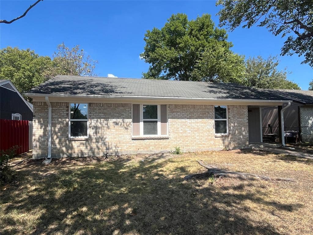 9615 Oak Gate Lane, Dallas, TX 75217 Brick facade with contrasting window shutters, gabled roofline, and attached covered porch