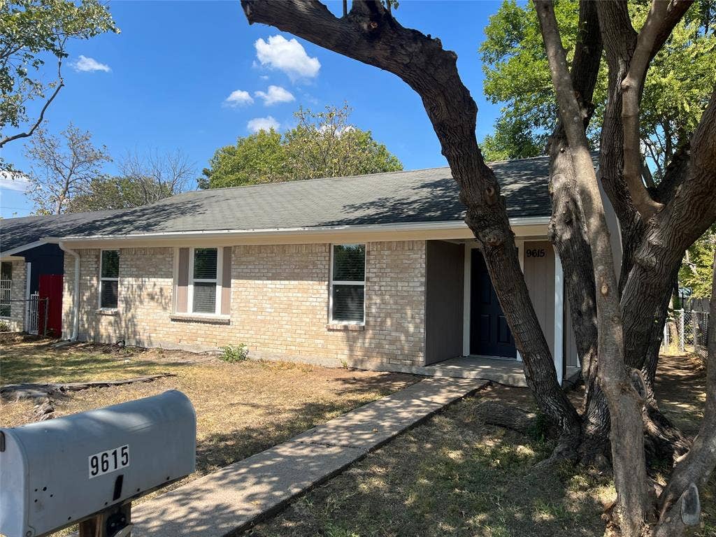 9615 Oak Gate Lane, Dallas, TX 75217 Brick exterior with light-colored trim and a gray shingle roof