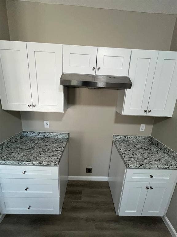 9615 Oak Gate Lane, Dallas, TX 75217 White shaker-style cabinetry, stainless steel range hood, stone-finish countertops, wood-finish flooring, and neutral wall paint